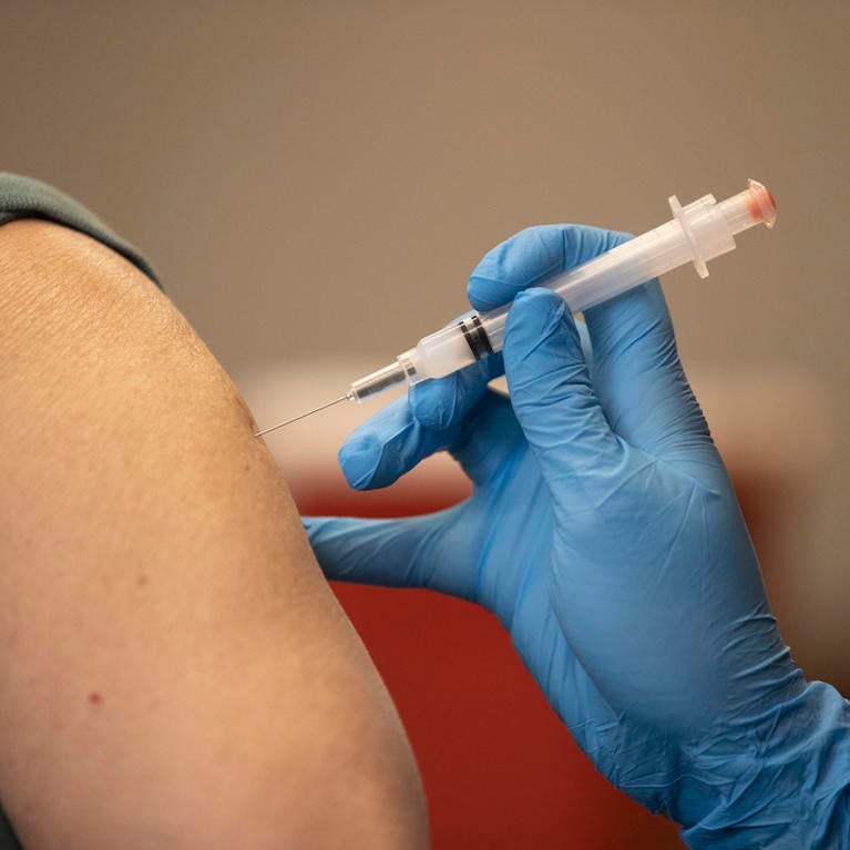 Ann arm is seen receiving the COVID 19 vaccine